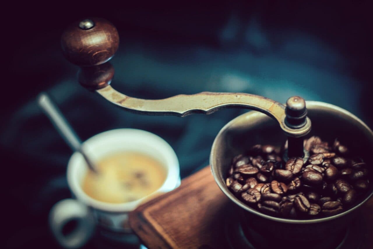 Coffee beans in a hand grinder